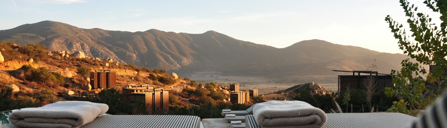 sunloungers fronting buildings near mountain